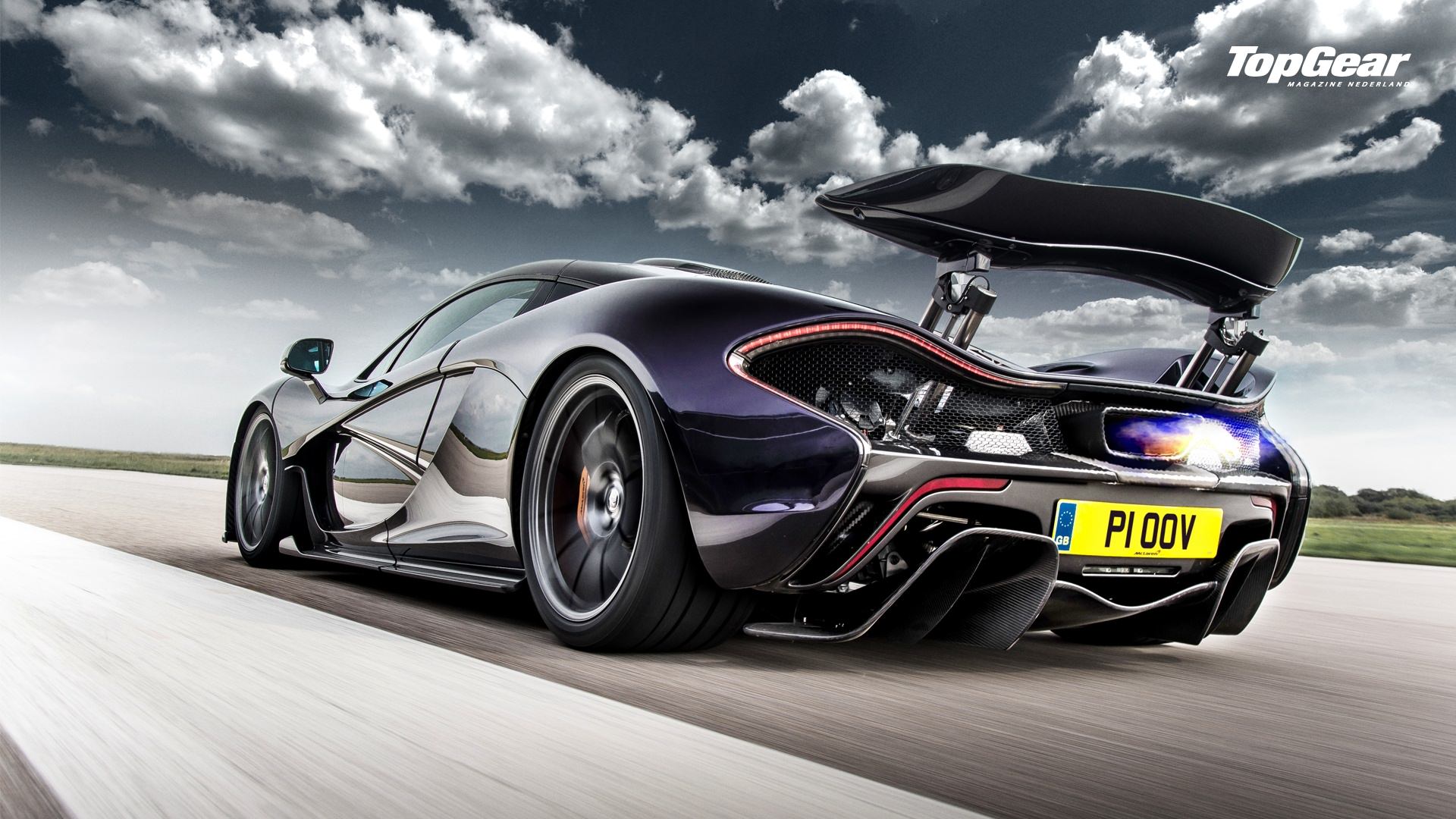 Awesome purple McLaren P1 rear side view shooting flames on the track - image via top