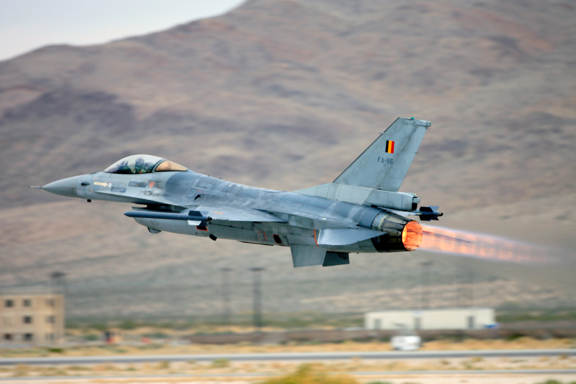 A Belgian air force F-16 Fighting Falcon takes off with full afterburning power.