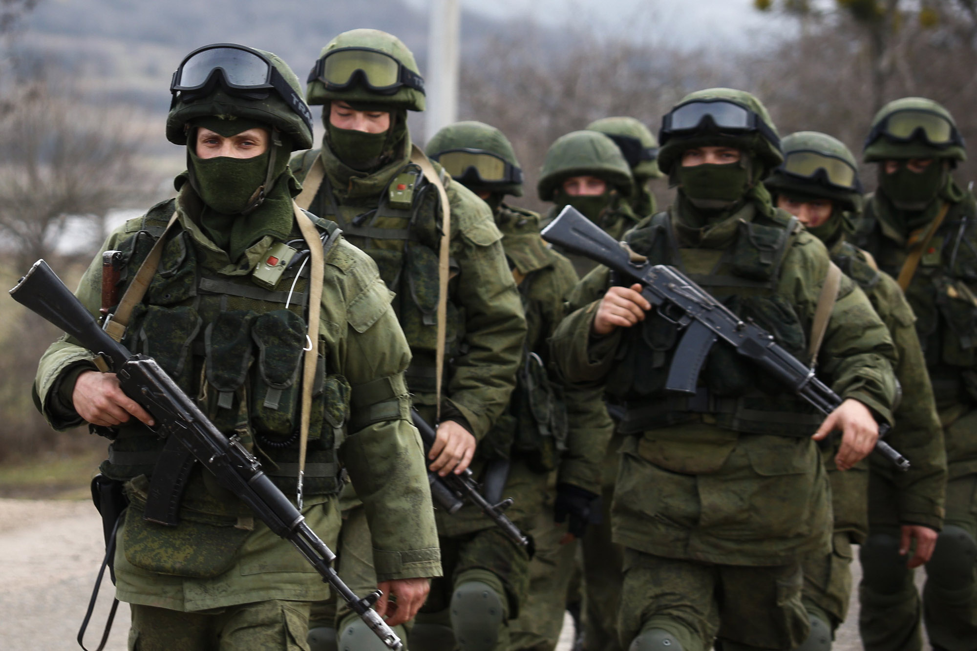 Armed men, believed to be Russian servicemen, march outside a Ukrainian military base near the Crimean city of Simferopol.Photo: Reuters