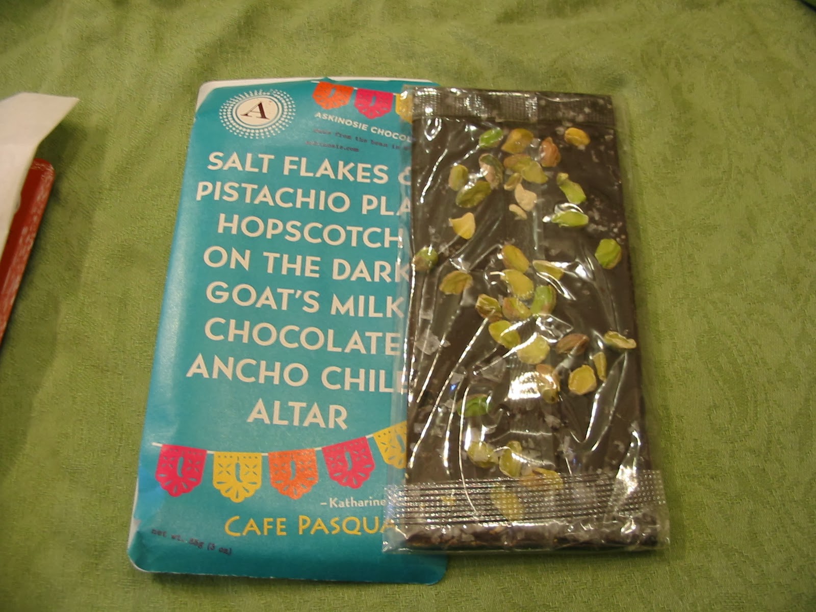 Cafe Pasqual's has sea salt flakes, Pistachio, and dark milk chocolate made with Goat's milk and some ancho chile! WOW, that quite a collection of flavors.