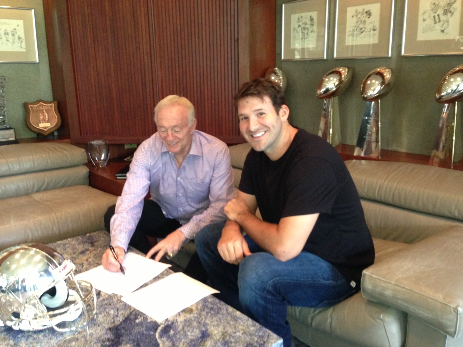 Cowboys QB Tony Romo along with Cowboys Owner Jerry Jones sign Tony's new contract extension on