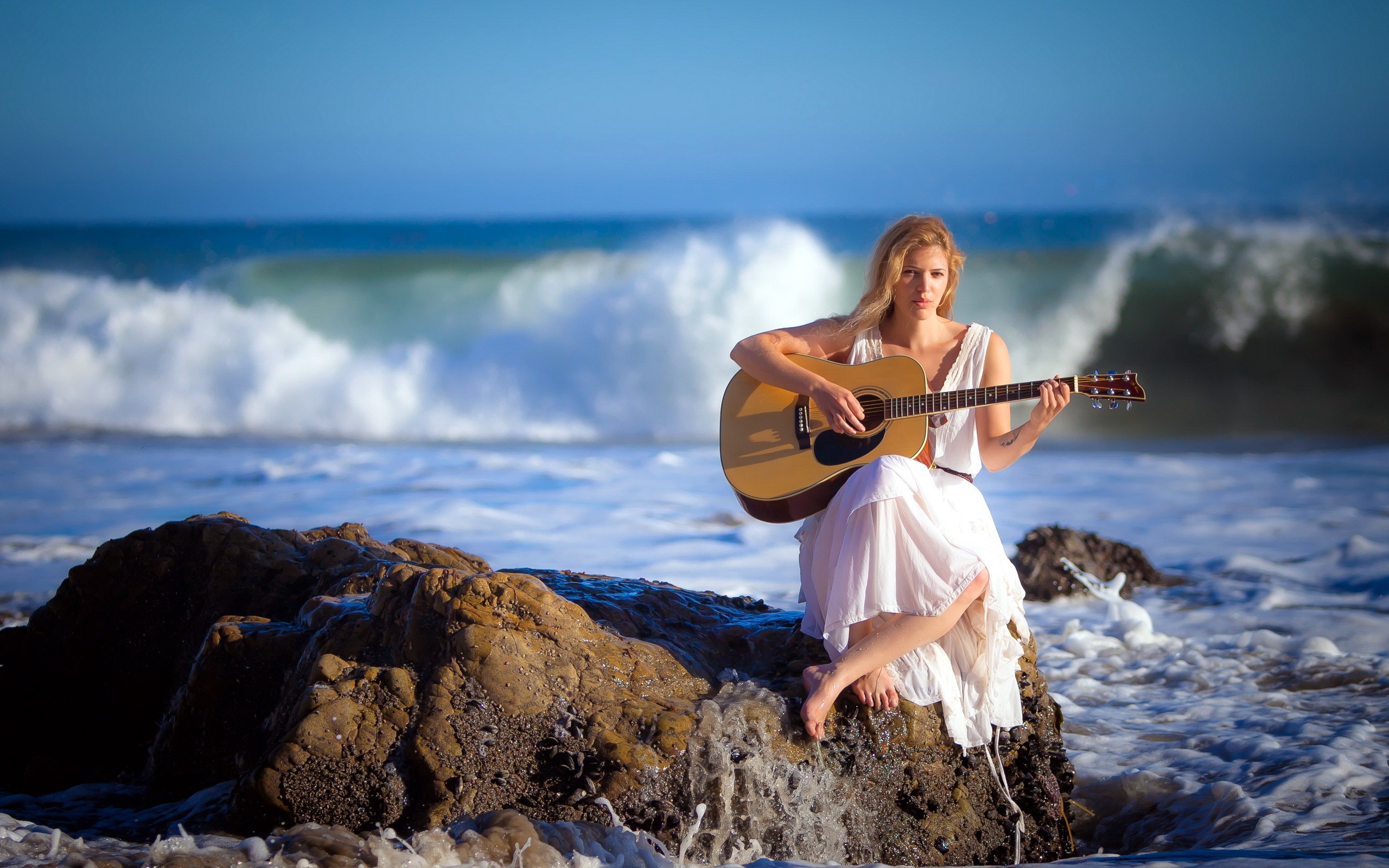 Woman playing guitar coast