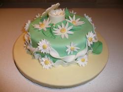 It is an 8 inch round cake covered in green fondant. The board is also covered in yellow fondant. I made daisies ...