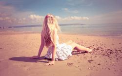 Lonely girl sitting on beach