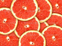 Abstract red background with citrus-fruit of grapefruit slices. Close-up. Studio photography. — Photo by boroda