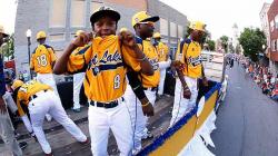 Members of the Jackie Robinson West Little League team from Chicago, Ill., ride