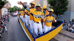 Members of the Jackie Robinson West Little League team from Chicago, Ill., ride