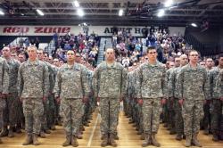 ... 125th National Guard Infantry Regiment stand before friends and family during a departure ceremony at Grand Blanc High School on Monday night.