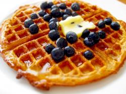 Epic closeup of a waffle with blueberries.